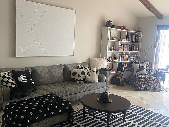living room with high ceiling and door to yard
