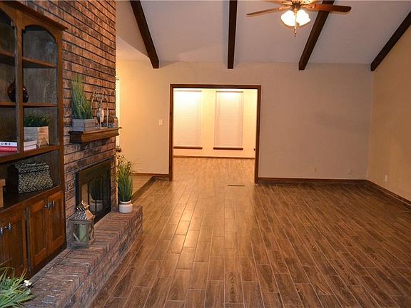 Living room opens to the sunroom.  New wood-look ceramic tile throughout all rooms except bedrooms