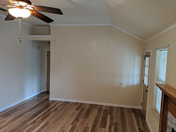 Maln living area with wood burning fireplace and high ceilings