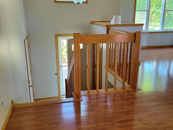 Stairs from the living room to the front entrance and garage (dining on the right side)