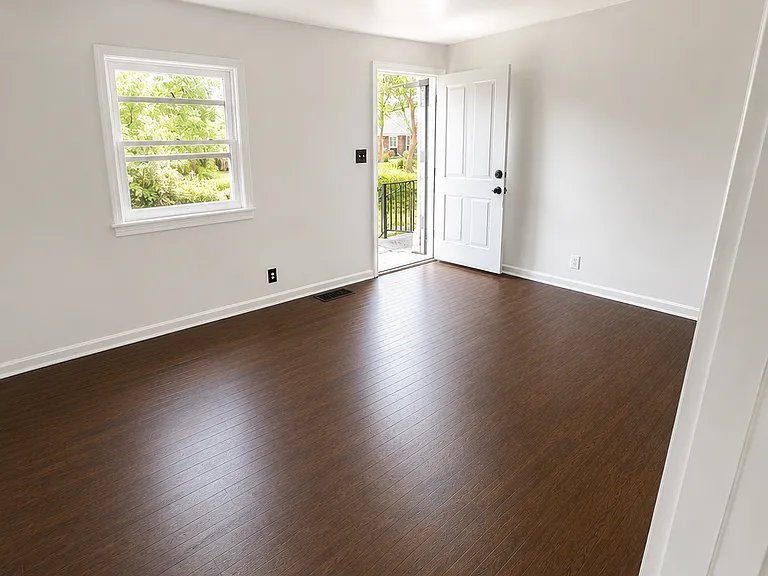 Spacious living area with hardwood floors and plenty natural light.