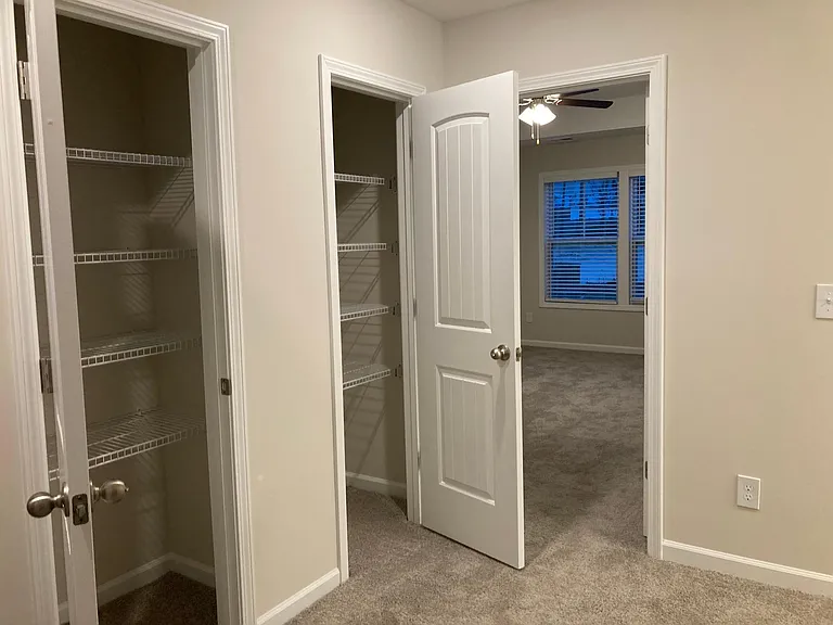 Upstairs foyer showing two extra closets at top of stairs.