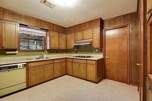 Kitchen boasts granite countertops and ceramic tile floor.