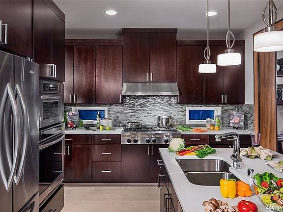 Gourmet Kitchen features granite countertops & stainless appliances. Photo not of actual home - may contain optional features.