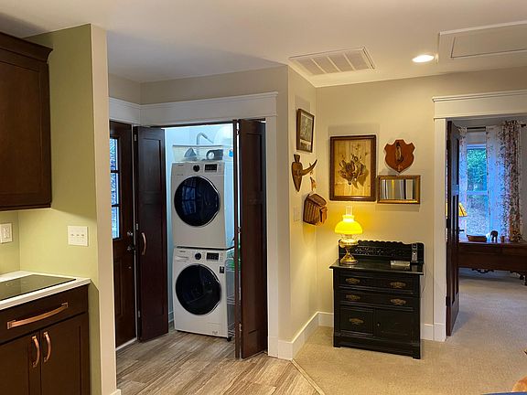 Stacked washer and dryer in entry closet.
