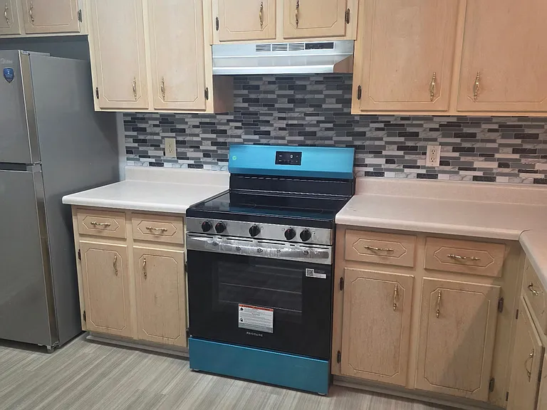 Kitchen with brand new SS appliances and backsplash