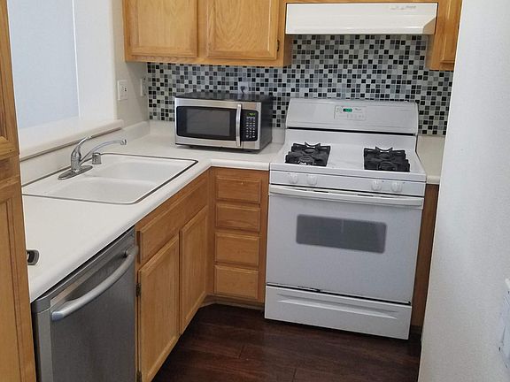 Kitchen with gas stove, dishwasher, fridge and microwave