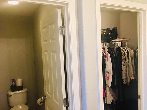 Toilet room and walk in closet.