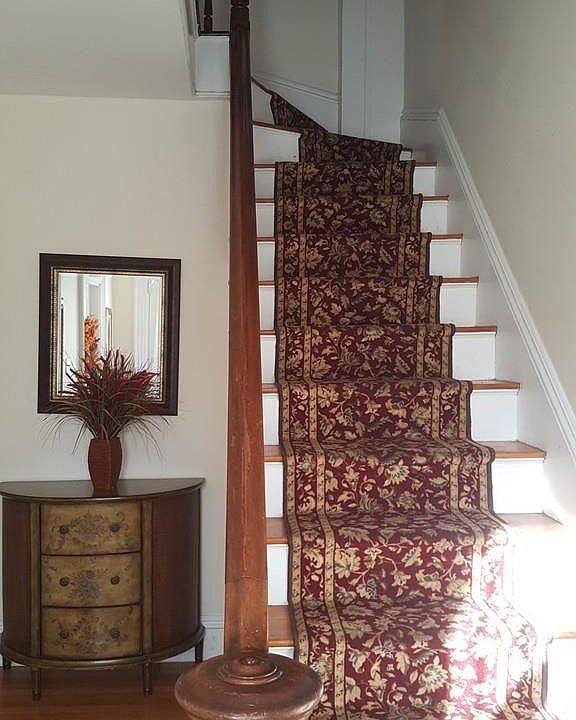 Beautiful staircase leading up to the upper unit.
