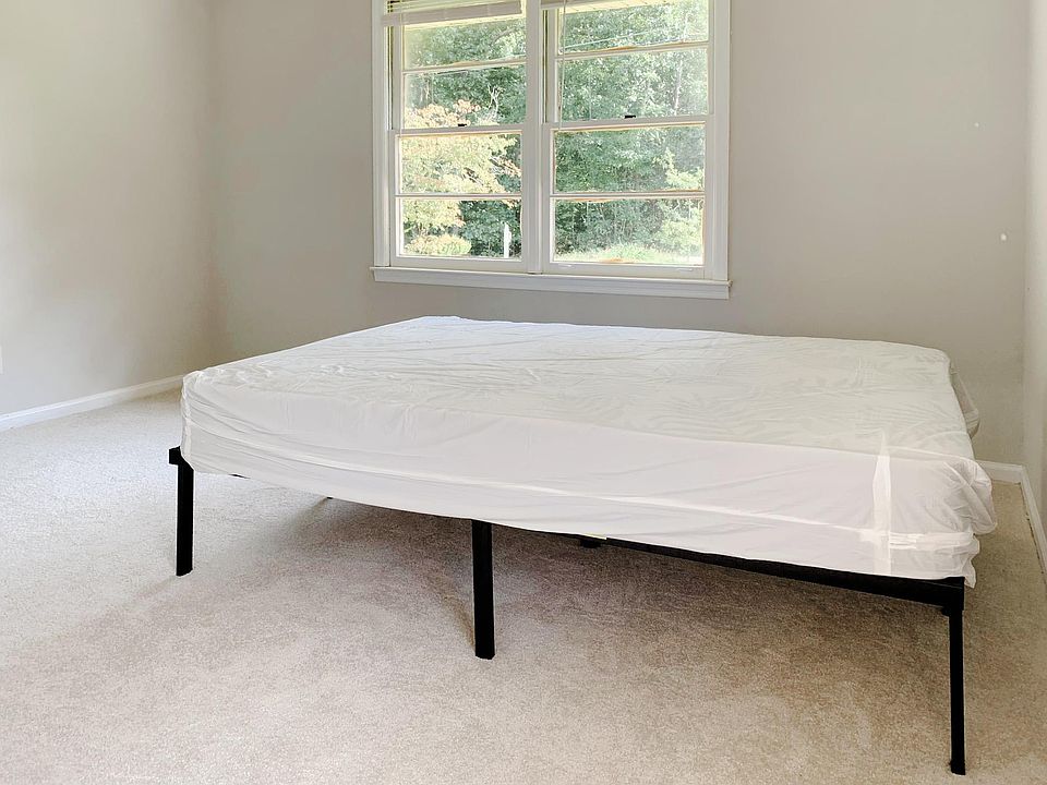 Total of three windows in this carpeted room!