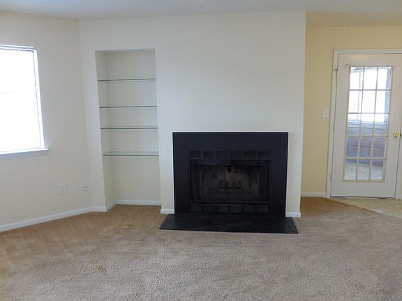 living room featuring wood burning fireplace