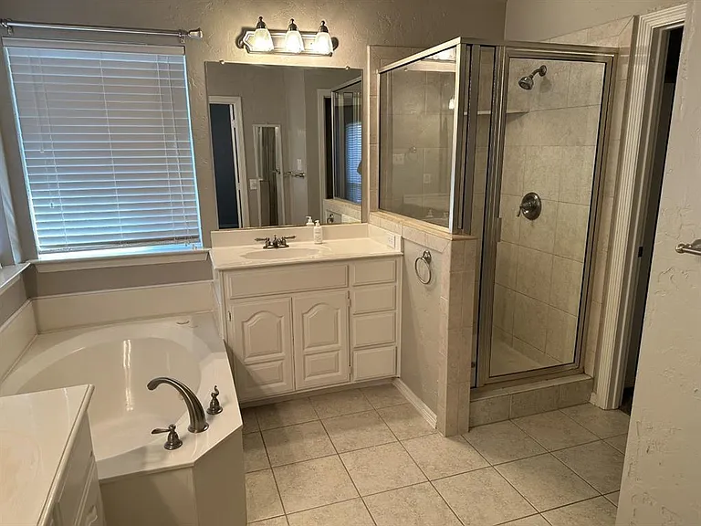 Master bath features the jetted tub, two vanities and separate stand up shower.