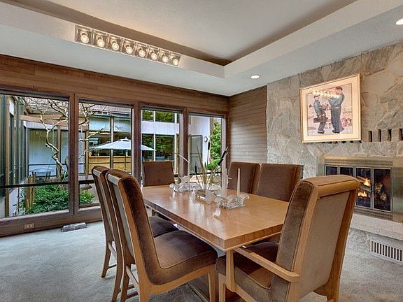 Currently used as a dining area this room can also be used a living room. Coffered ceilings, cedar tongue-in-groove walls and white fieldstone add to this rooms ambiance.