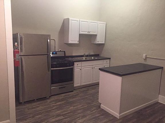 Kitchen with brand new refrigerator, range, cabinets, and co