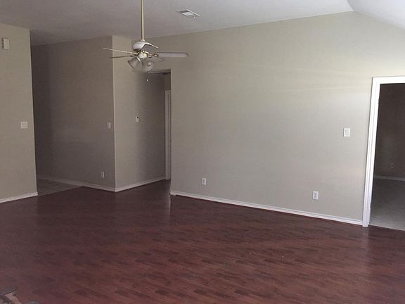 Family room ( Laminate flooring) door entry (R) to master bedroom and middle bedroom and passageway (L) to front door.