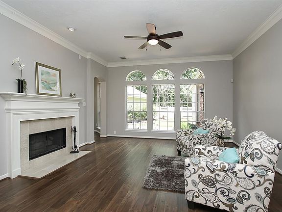 The Spacious Den has a Wall of Windows overlooking the Patio and Serene Back Yard, Double Crown Molding...