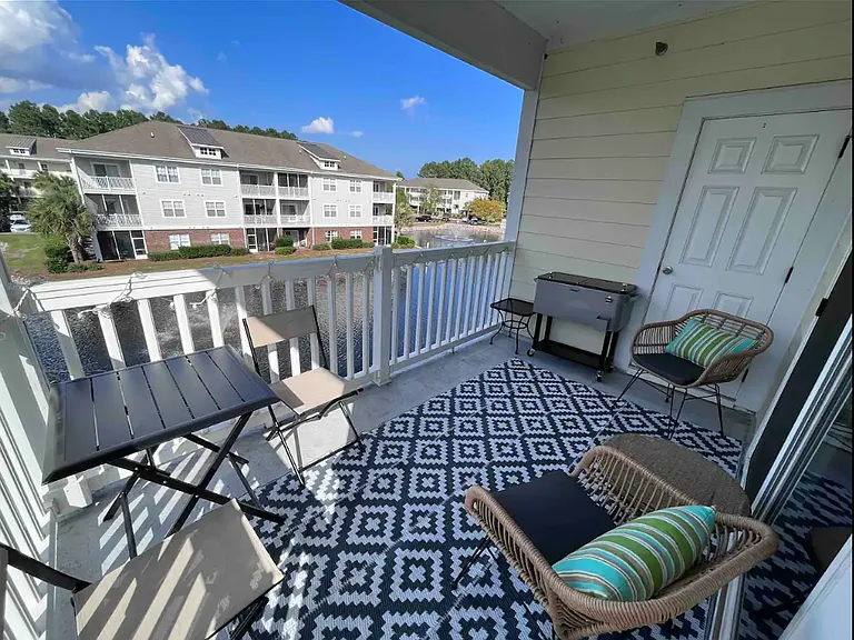 Balcony seating for four with side tables and a cooler to keep your drinks cool. Balcony closet has a few beach chairs and sand toys for your use during your stay.