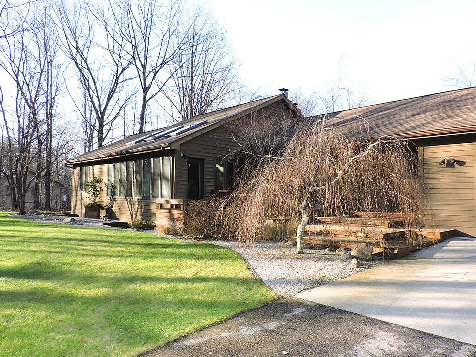 Onward and Upward...to this beautiful 4 Bedroom, 2.5 Bath home on 2.5 acres! With 1800 sq ft on the main floor and an additional 1600 finished sq ft in the walk out lower level, there's room for the whole family here. The spacious living room features a gas fireplace and French doors to the expansive back deck overlooking a partially fenced 2.5 acre secluded yard. You'll love the updated kitchen with its granite counters and stainless appliances. Sliders in the dining area lead to a fabulous sunroom with ceramic floors and newer skylights. A second set of sliders lead from the sunroom to the huge master suite complete with a jet tub and bay window overlooking the yard. The lower level features a family room with a wood burning fireplace and walkout to the backyard, 2 spacious bedrooms, a full bath, and a den. You will adore the quiet wooded setting, just minutes from town, and enjoy the Bullock Creek school district. Don't miss out, call today!