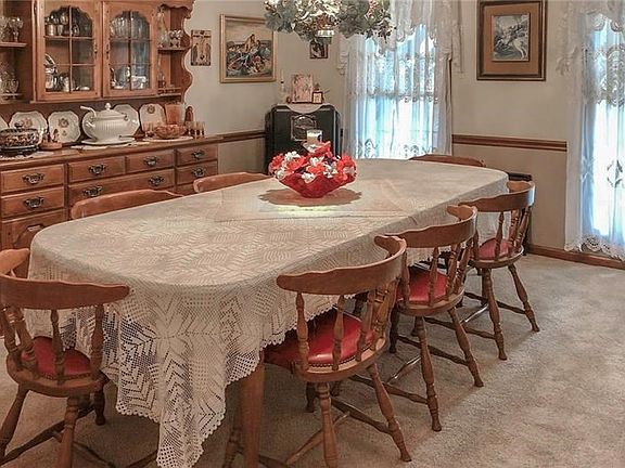 Dining Room with Crown Molding, Chair Rail and Neutral Carpet