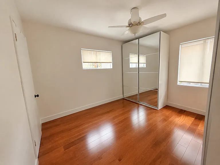 Bedroom with added closets, ceiling fan, and new mini split ac system.