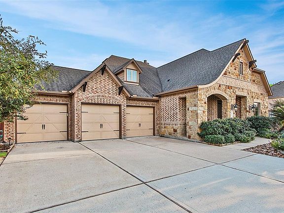 Triple wide driveway makes it easy for party-never need to park on the street. Notice the wood trim accent pieces above the garage and front porch area.