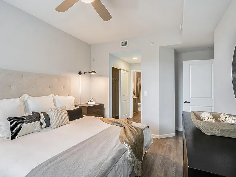 Bedroom with Ceiling Fan, Walk-In Closet, and Access to Attached Bathroom