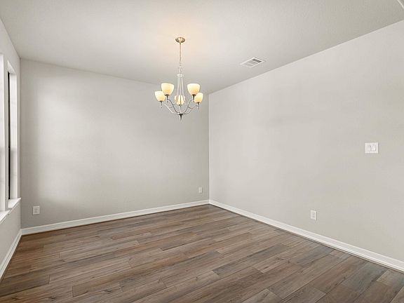 Gather the family and friends in your formal dining room, complete with gorgeous flooring and a mode