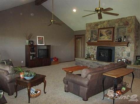 Spacious Living Room with vaulted ceiling and beautiful stone fireplace with pellet insert.