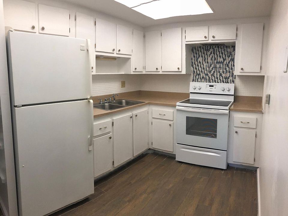 Kitchen with brand new stove and glass block back splash accent.