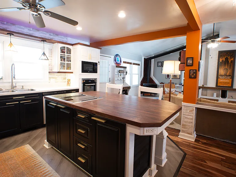 Custom kitchen with oversized island. Kitchen includes ample lighting, automatic dustpans (for easy sweeping - connected to central vac) dishwasher, garbage disposal, wall oven, wall microwave, and electric downdraft cooktop.