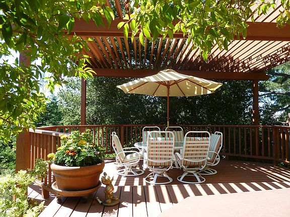 The Sky Deck sits underneath an arbor shaded by an old oak tree.