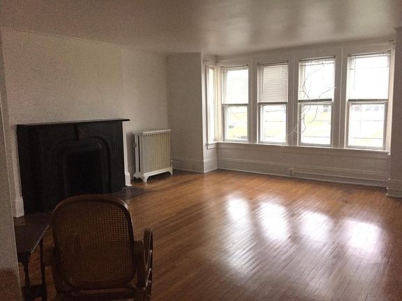 Bright, Freshly painted living room with decorative firelpla