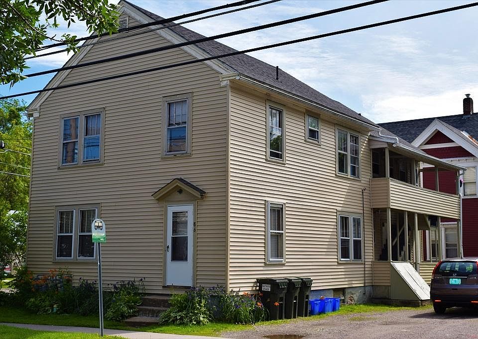 Main triplex has parking and coin op laundry