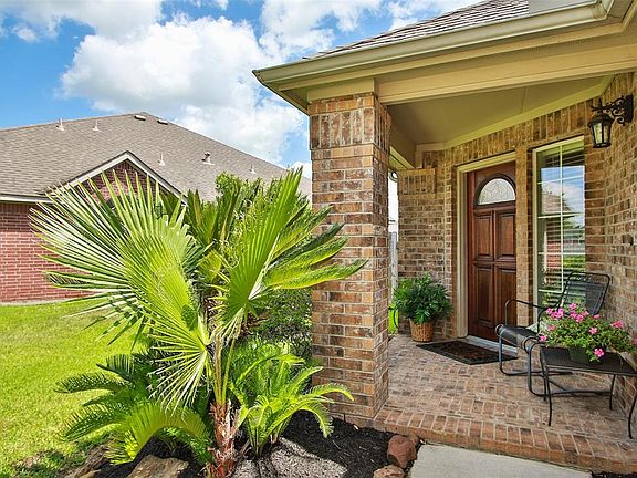 Side placed brick entry with freshly stained entry door.