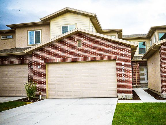 Exterior Garage and Sidewalk leading to entrance.