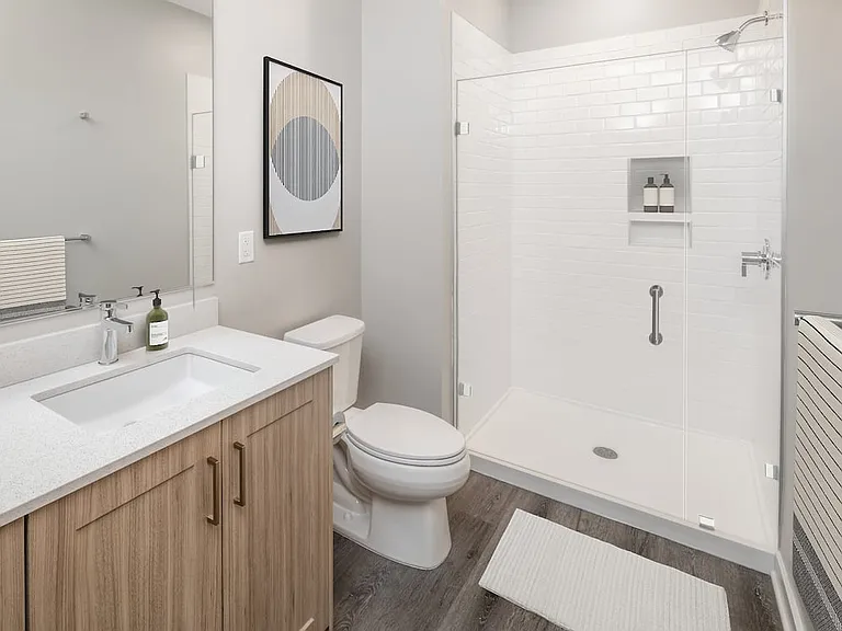 Base Collection bath with quartz countertops, oak cabinetry, and hard-surface flooring
