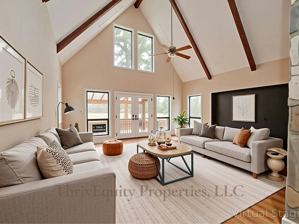 Spacious living room with vaulted ceilings, fireplace, and generous natural light.