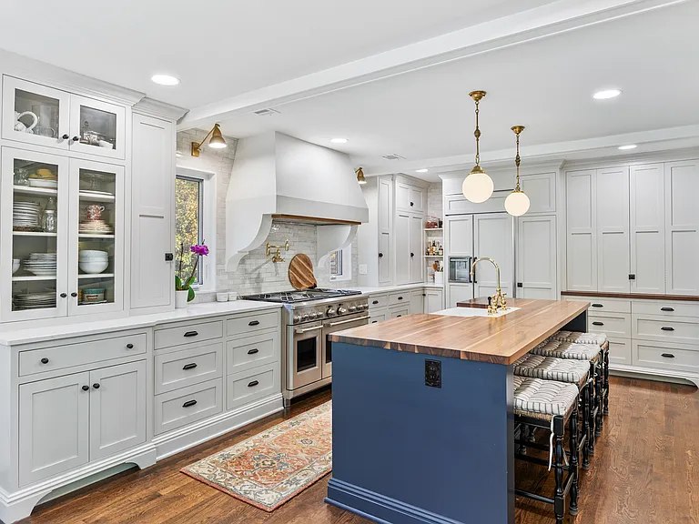 Recently updated state-of-the-art kitchen with a gas range, farm sink, all the dishware and appliances you might need, and seating for four at the kitchen counter.