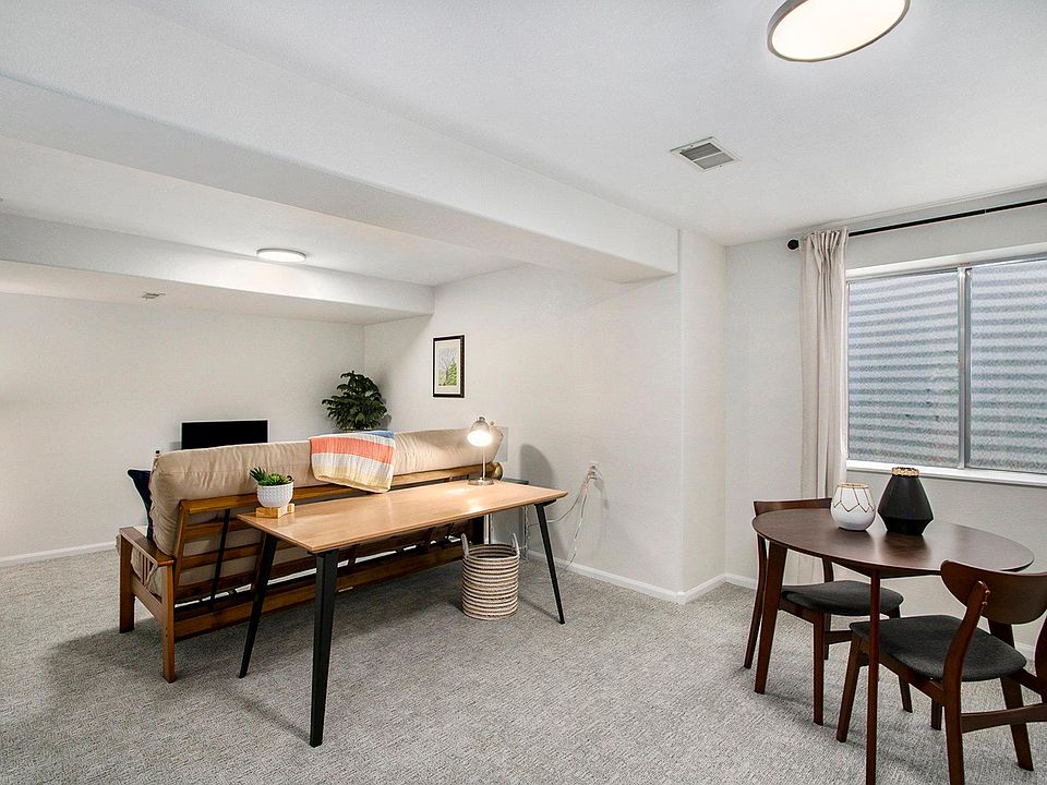 After coming down the stairs, you'll walk to the dining and kitchen area. The living room is on the other side of the desk.