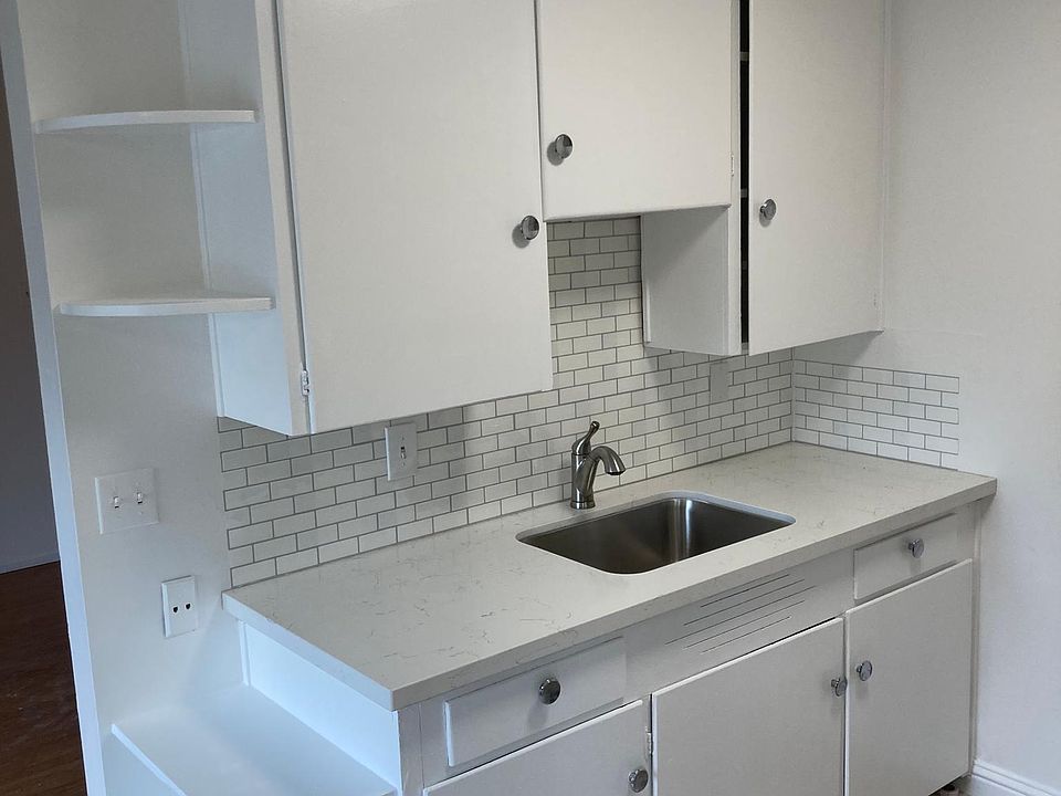 Recently renovated kitchen with new counters, backsplash, appliances, and paint.