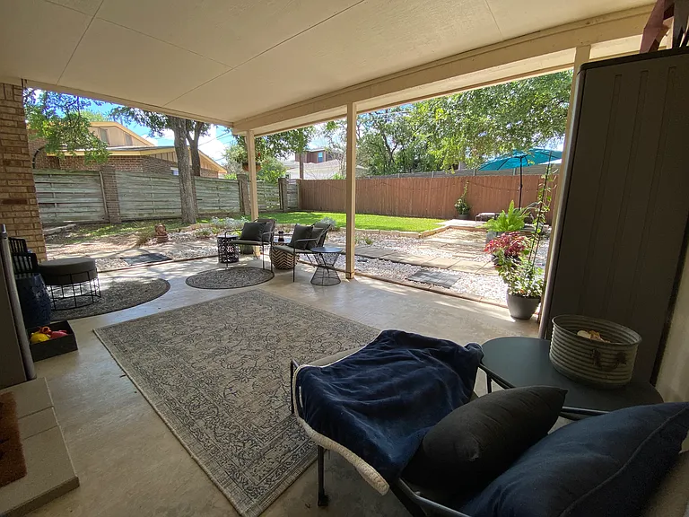 Large covered porch and charming fenced yard