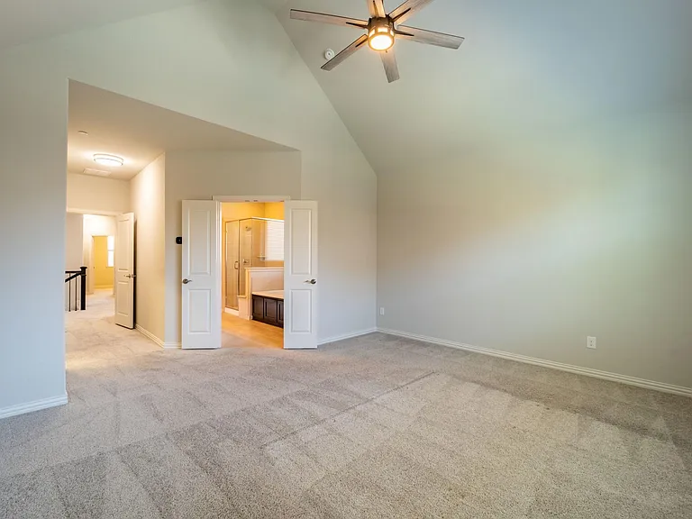 Double doors lead you to the luxurious primary bath