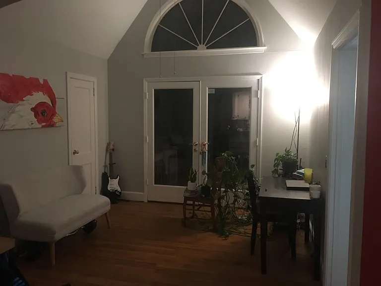 the view from the kitchen into the sunroom. French doors lead to the deck and backyard