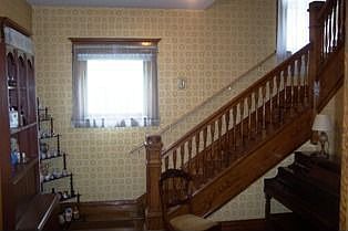 Foyer with open oak staircase.