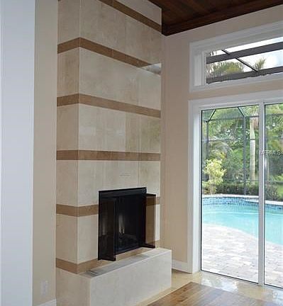Living Room Fireplace Overlooking Lanai and Pool