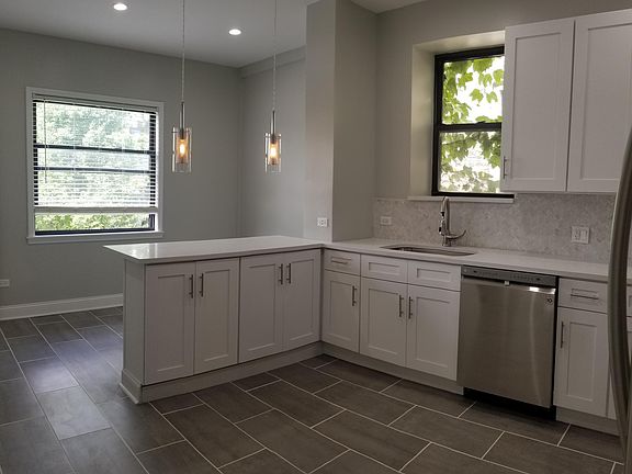 other angle kitchen- rear window has been replaced to patio door leading to huge private outdoor deck!