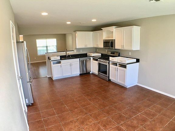 Kitchen view from the back door. Large dining area. Stainless steel appliances. New cabinets. Pantry.