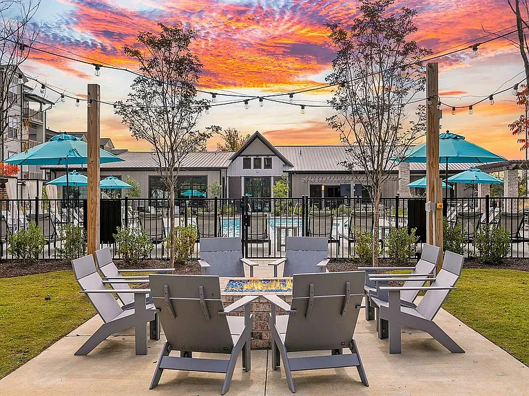 Relax in style at this stunning outdoor patio, complete with a fire pit and poolside views.