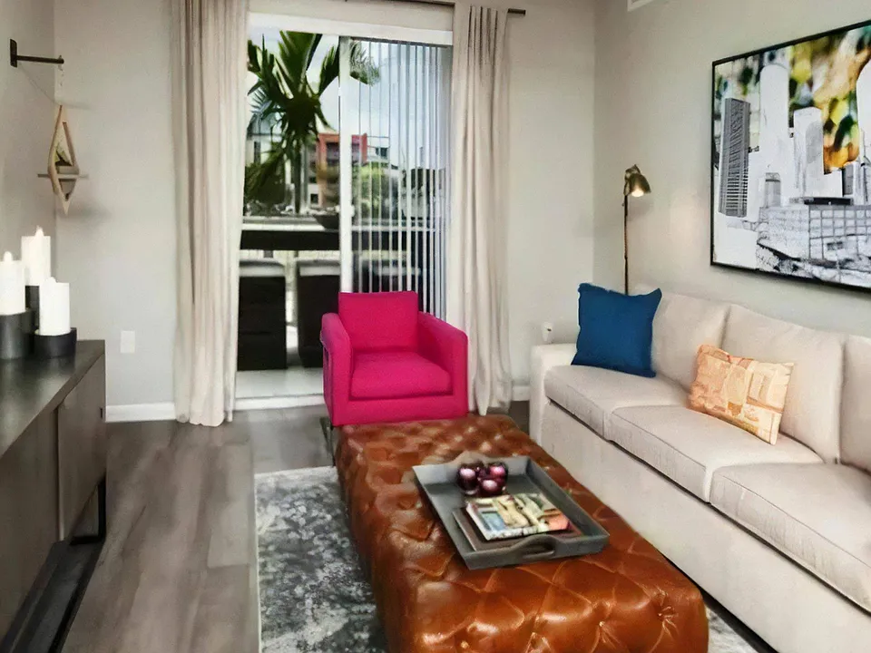 Open Living Room with Sliding Balcony Door, Leather Ottoman, and Framed City Artwork