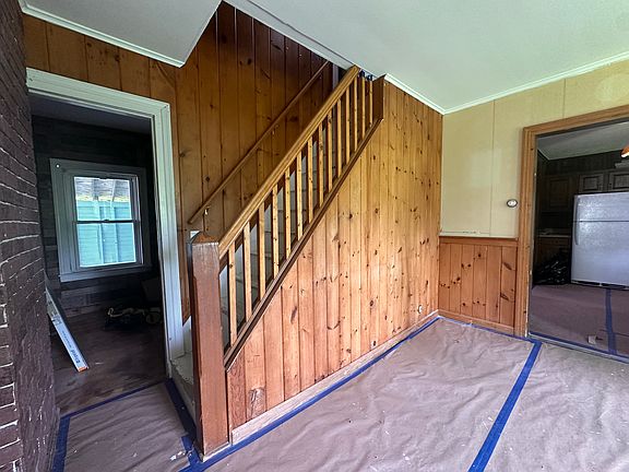 Dining room has beautifully restored hardwood floor under the protection paper, and the walls will receive new wallpaper.